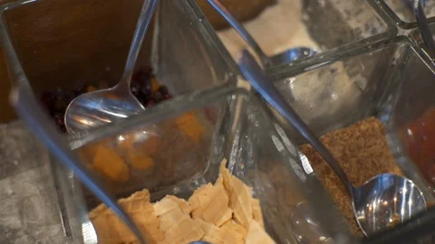 Supplements for ice cream or yogurt. Muesli, granola, candied fruits and chia Stock Footage 101644097