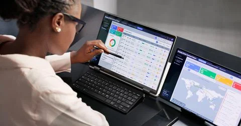 Supply Chain Manager Uses Digital Dashboard On Laptop To Track Shipments. Stock Photos