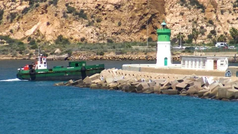 Supply ship sailing close to the lighthouse of the port. Stock Footage 110618087