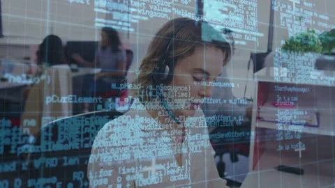 Support agent adjusting mic, typing as code overlay thinning, revealing monitor Stock Footage 332642512