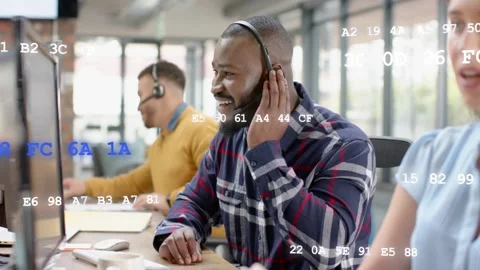 Support agent on call adjusting mic smiling typing helping caller code overlay Stock Footage 333105635