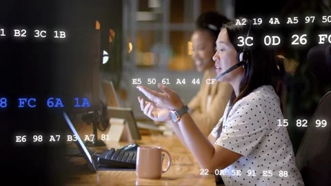 Support agent taking call via headset, speaking and gesturing with code overlay Stock Footage 333210909