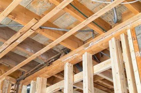 Support beams with wide opened ceiling during a house renovation Stock Photos