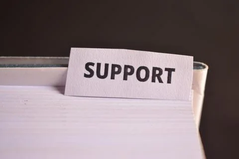 Support Bookmark Inserted in Book Representing Help, Assistance and Teamwork Stock Photos