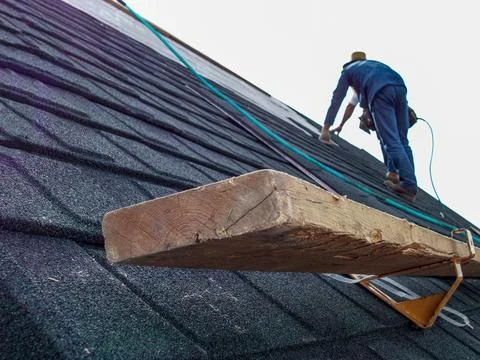 Support bracket and foot support on shingle roof installation Stock Photos