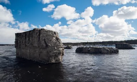 Support the destroyed bridge on river against blue sky Stock Photos