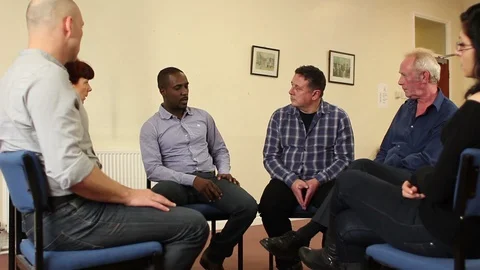 Support group therapy - Diverse People sat in circle for a recovery meeting Stock Footage