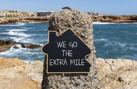 Support, help we go the extra mile symbol. Concept words We go the extra mi.. Stockfoto's
