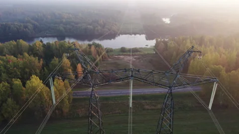 Support of a high-voltage power line with wires thrown across the river. Video stock 164142312