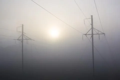 Support of high-voltage transmission lines in fog Stock Photos