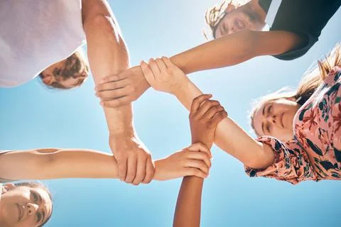 Support, holding wrists and friends in a circle for collaboration, trust and Stock Photos