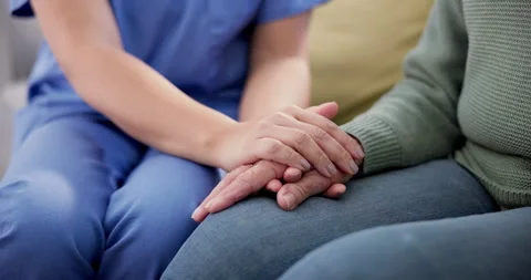 Support, hope and hands of senior woman with nurse on sofa for comfort, kindness Video stock 249727832