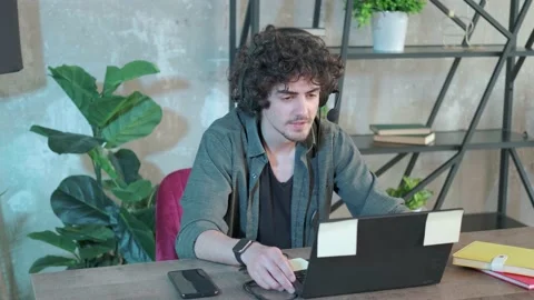 Support hotline worker with laptop and microphone at work. Stock Footage 154206433