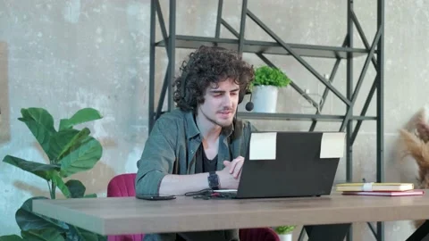 Support hotline worker with laptop and microphone at work. Stock Footage 154307793