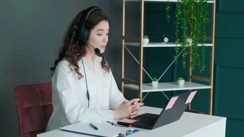 Support hotline worker with laptop and microphone at work. Stock Footage 154907907