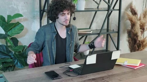 Support hotline worker with laptop and microphone at work. Stock Footage 156327433