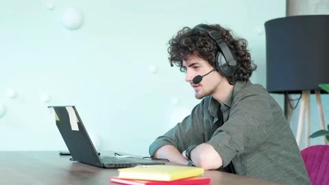Support hotline worker with laptop and microphone at work. Stock Footage 168976783