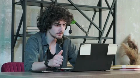 Support hotline worker with laptop and microphone at work. Stock Footage 222577284