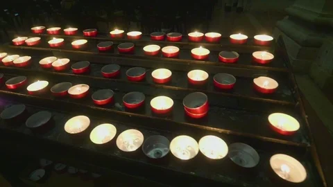 Support with lit candles inside a dark church. Stock Footage 107425448