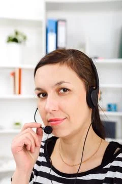 Support phone operator in headset at workplace Stock Photos