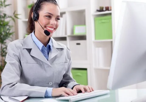 Support phone operator in headset at workplace Stock Photos