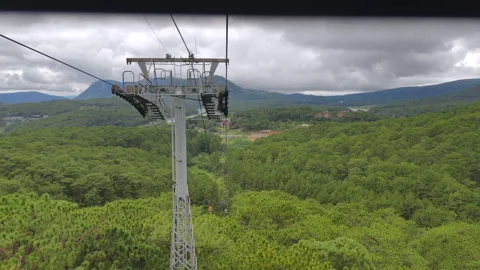 A support pylon of the cable car amid the tops of pine trees. Stock Footage 317884147