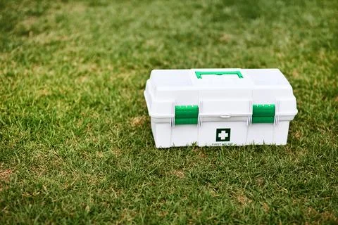 Support for those on-site sports injuries. a first aid kit on a rugby field. Stock Photos