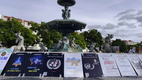 Support Ukraine Protest Posters In Lisbon Fountain in Public Square Stock Footage 330051712