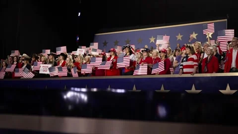 Supporters wave American flags in the stands behind the stage, RNC Dallas 2026 Stock Footage 345271796