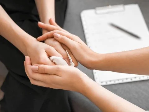Supportive hands in counsel session highlighting empathy and care Stock Photos