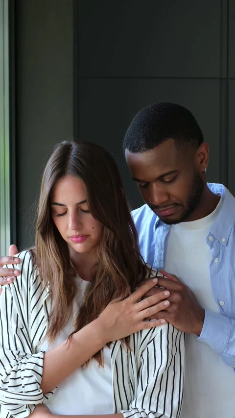 Supportive man comforting his sad grieving Stock Footage 334636475