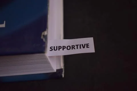 Supportive Paper Tab Between Book Pages Symbolizing Help, Guidance and Posi.. Stock Photos