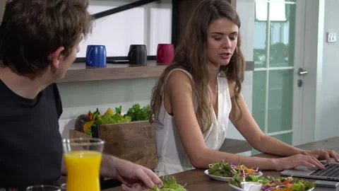 Supportive relationship Caucasian couple having dinner and work on computer.. Stock Footage 258344615