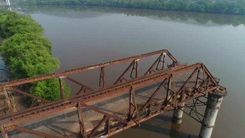 Supports and truss old, rusty, dilapidated bridge over the river. Aerial view. 스톡 동영상 85487888