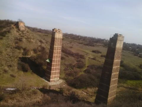Supports of the destroyed bridge. Stock Photos