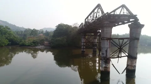 Supports old, rusty, dilapidated bridge over the river. Aerial view. Vídeo Stock 85480295