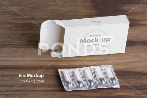 Suppositories loaf and an empty box on wooden table background mock-up series PSD Template