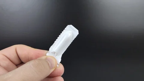 Suppositories in white packaging in the hands of a man. Macro video of rectal or Stock Footage 125894057