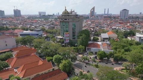 Surabaya, East Java - June 24 2025: Aerial of Street and Glass Office Building Stock Footage 338038623