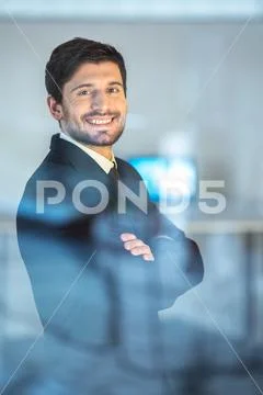 The sure businessman stand and cross hands near the window Stock Photos