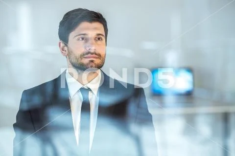 The sure businessman stand near the window Stock Photos