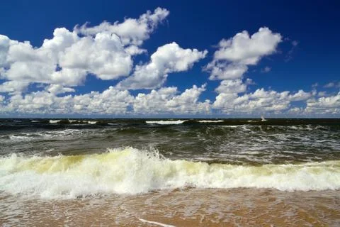 Surf and cumulus clouds Stock Photos