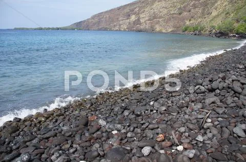 Surf and eroded lava rocks .. Stock Photos