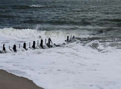 From surf and waves, as well as from the current strongly deformed groyne Stock Photos