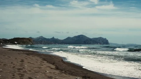 Surf in the bay against the backdrop of the mountains Stock Footage 72775627