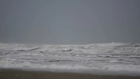 Surf on a beach of the North Sea on a cloudy day Stock Footage 154742606