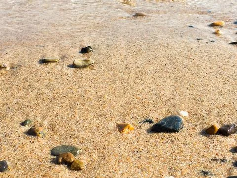 Surf on the beach, sandy beach with pebbles Stock Photos