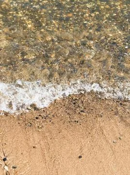 Surf on the beach, sandy beach with pebbles Stock Photos