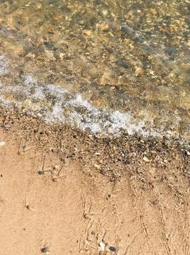 Surf on the beach, sandy beach with pebbles Stock-Fotos