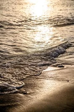 Surf on the beach at sunset 写真素材